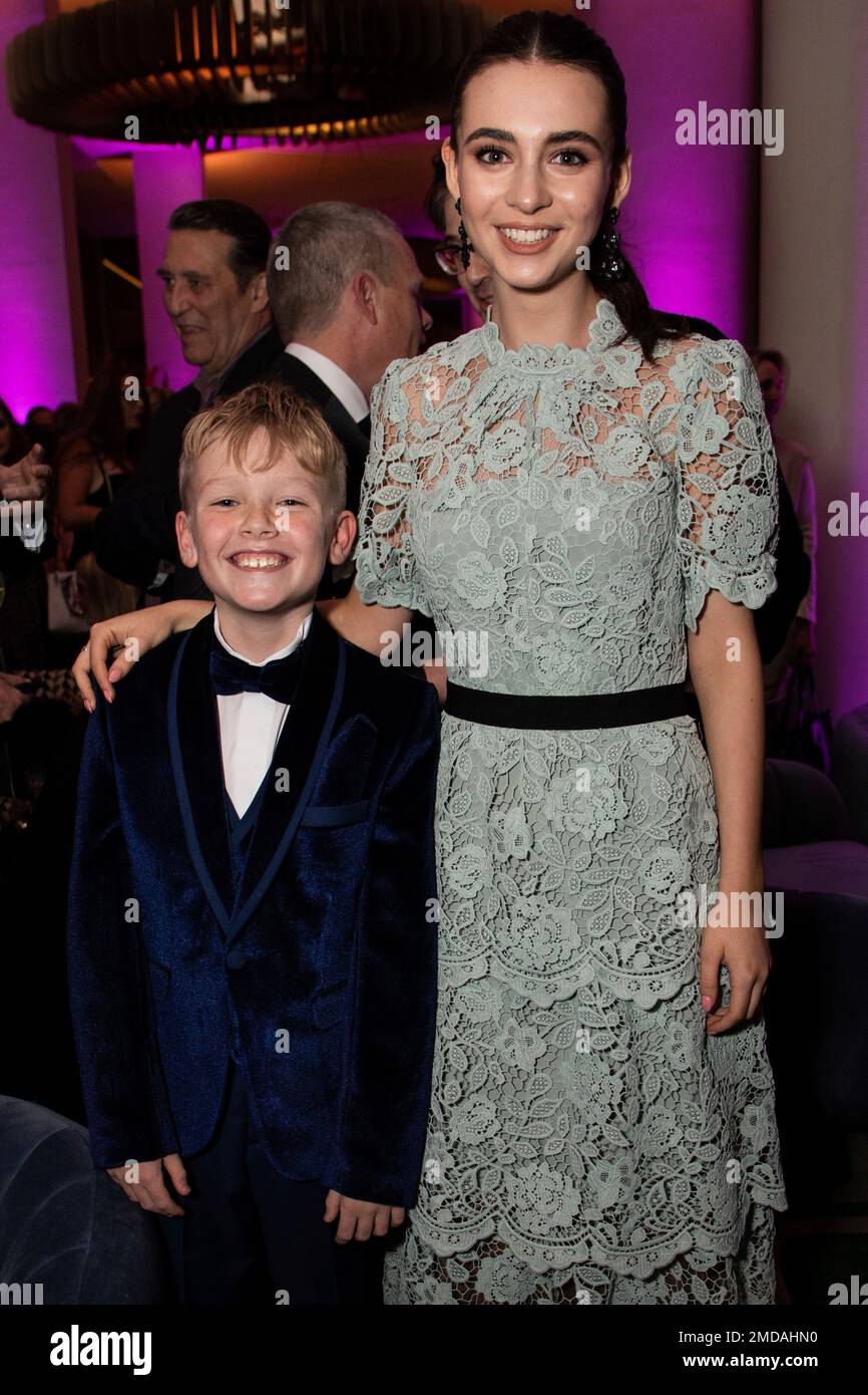 Jude Hill, left, and Lara McDonnell pose for photographers at the party