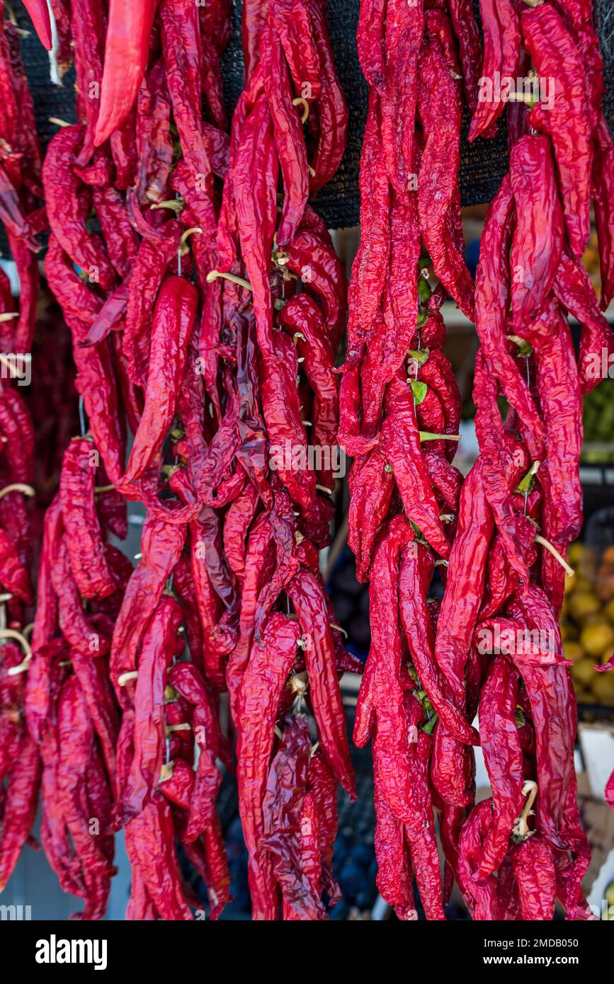 Paestum, Capaccio, Salerno, Italy - August 1, 2018: Garlands of Crusco Peppers hung for drying in front of shop Stock Photo