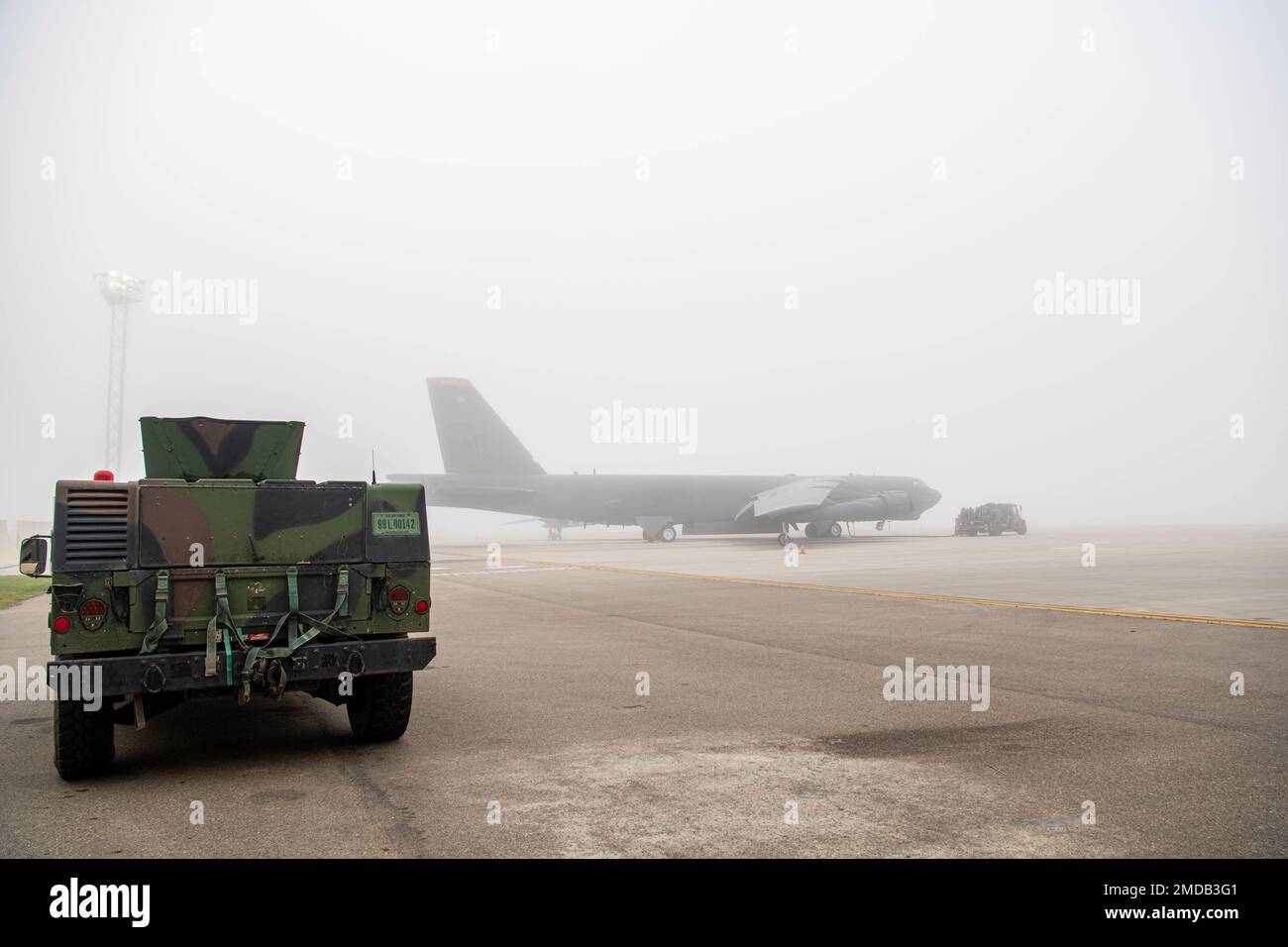 A B52H Stratofortress sits on a flight line preparing for flight at
