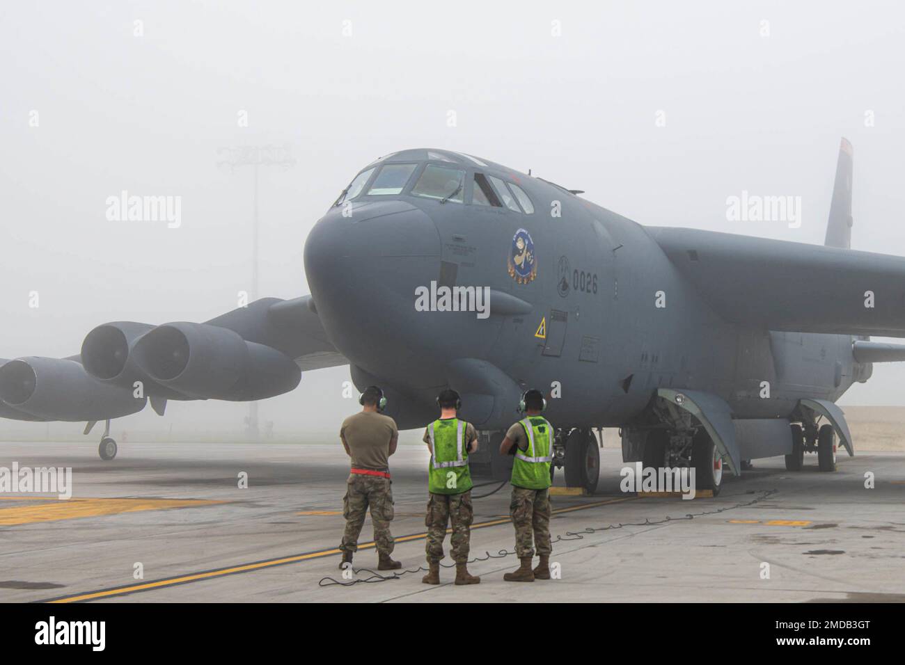 A B52H Stratofortress sits on a flight line preparing for flight at