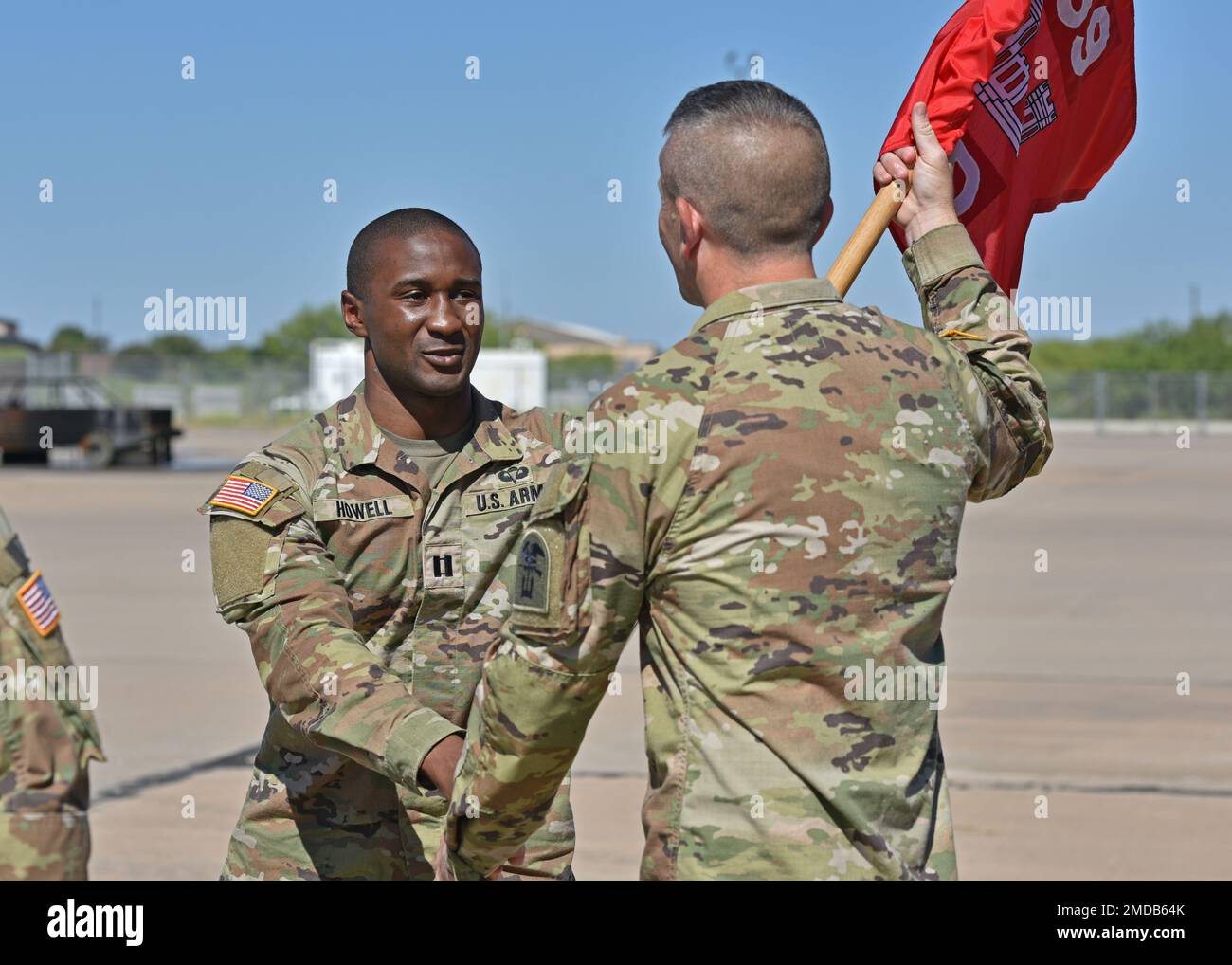 U.S. Army Capt. Jarred Howell, left, incoming Delta Company 169th Engineer Battalion commander, passes the guidon to 1st Sgt. Elisha Conway, D CO 169th EN BN first sergeant, during their change of command at Goodfellow Air Force Base, Texas, July 15, 2022. Howell was previously the commander of Bravo Company 169th EN BN. Stock Photo