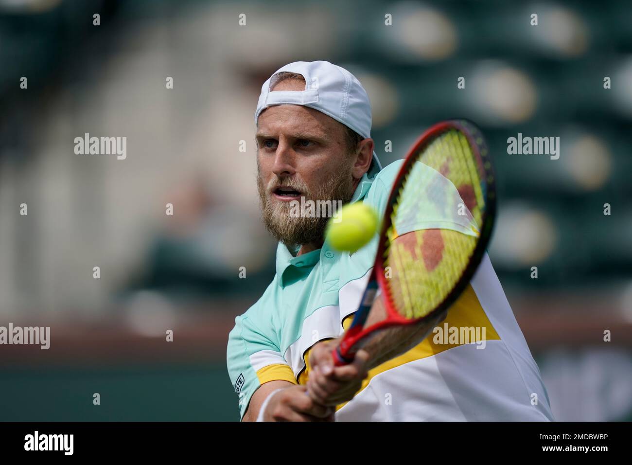 Denis Kudla, of the United States, returns to Alejandro Tabilo, of Chile, at the BNP Paribas Open tennis tournament Friday, Oct. 8, 2021, in Indian Wells, Calif