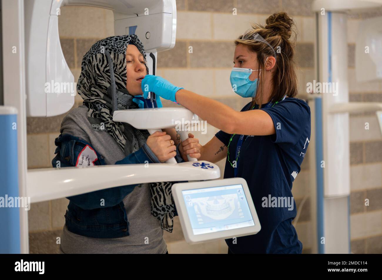 A Missouri Mission of Mercy volunteer positions a patient during a free