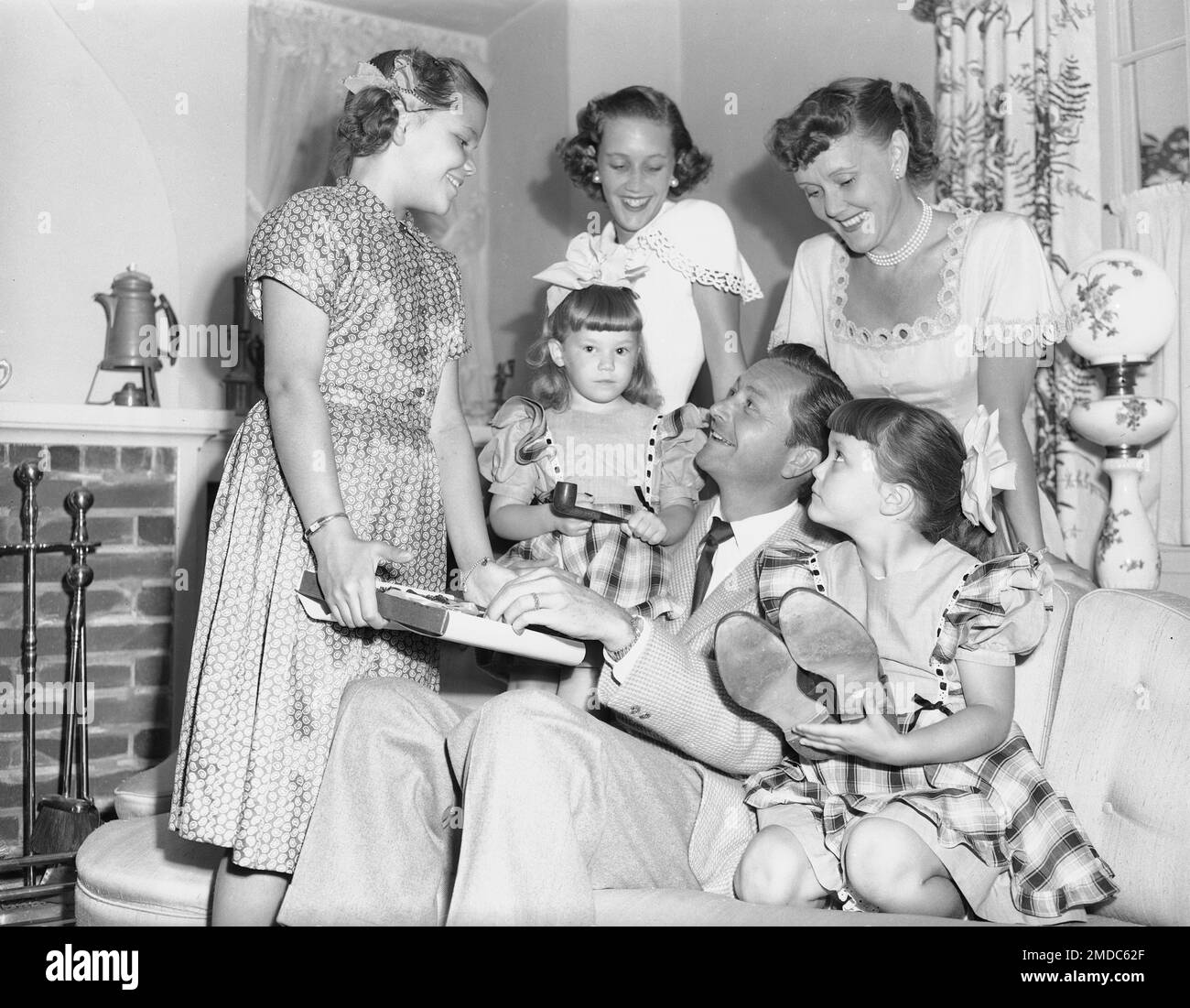 Actor Robert Young's family gets him warmed up for Father's Day, June 17,  1949. His wife Betty stands at right. The girls are, from left: Barbara,  11; Kathy, 3, Carol Anne, 15;