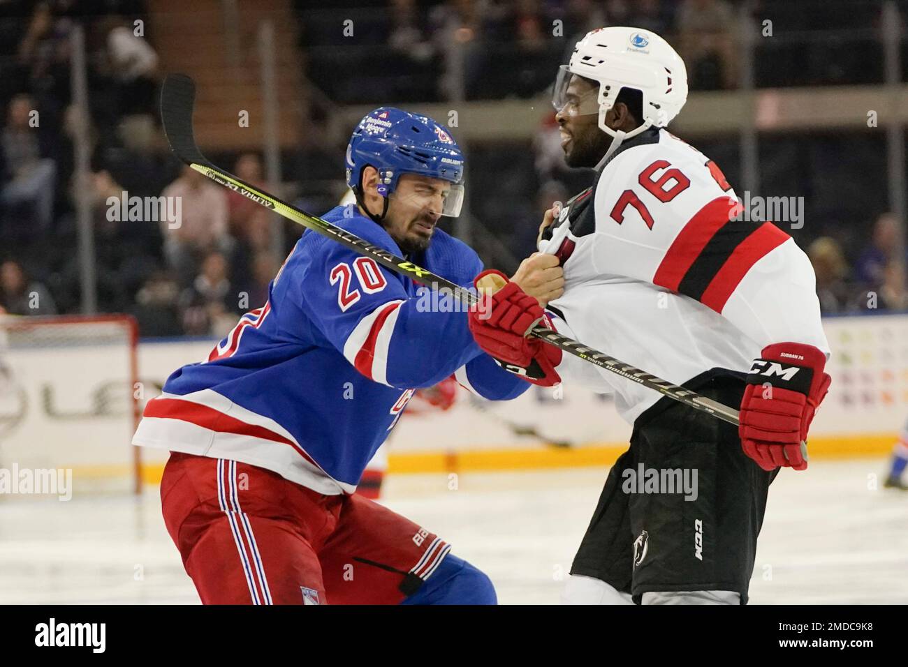 New York Rangers' Chris Kreider (20) grabs the jersey of New Jersey Devils'  P.K. Subban (76) as they exchange words during the second period of an NHL  preseason hockey game Wednesday, Oct.