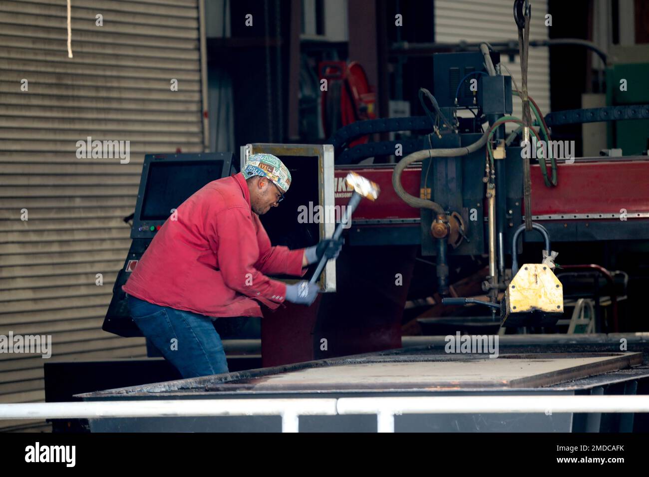 Michael Dunning Jr., a welder at the Army Corps of Engineers runs a PlateProX HD Large CNC Plasma/Oxy-fuel capable metal cutting machine, to cut out a 2 inch flange (donut) for the machinist to work on in the process of completing a off site project. Stock Photo