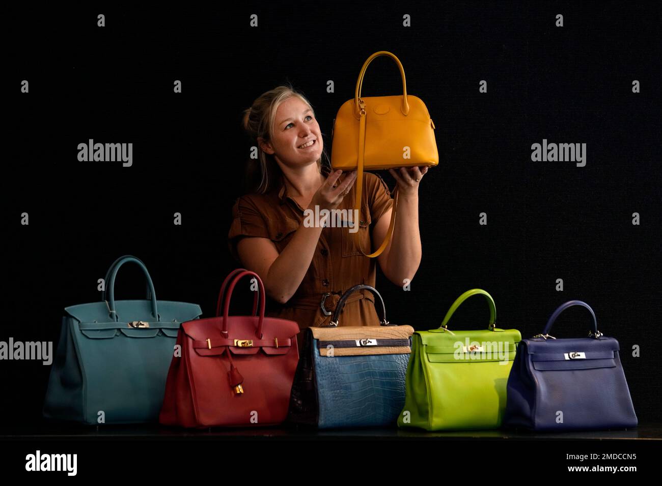 a bonhams employee displays designer handbags at the auction house in london wednesday oct 6 2021 bags and fashion items with estimates ranging from 400 40000 uk pounds 540 54250 us dollars will be up for auction at bonhams in london on oct12 in the designer handbags and fashion sale ap photokirsty wigglesworth 2MDCCN5