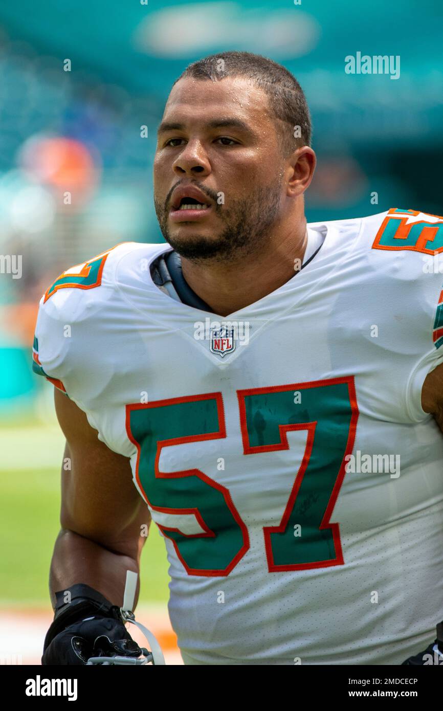 Miami Dolphins linebacker Brennan Scarlett (57) runs as he warms up on the  field before the start of an NFL football game against the Indianapolis  Colts, Sunday, Oct. 3, 2021, in Miami