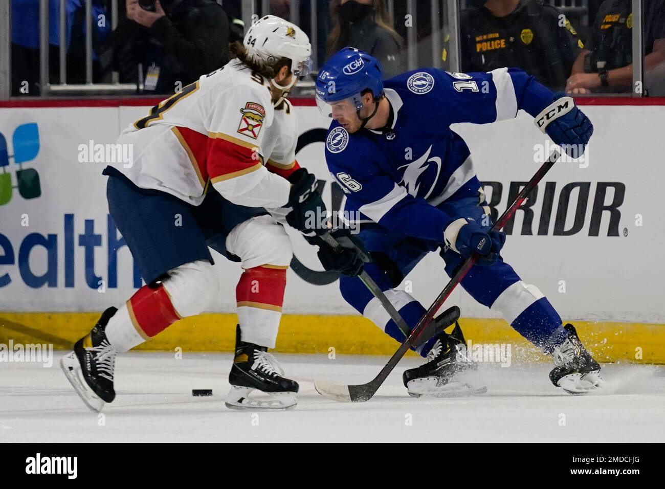 Tampa Bay Lightning's Taylor Raddysh, right, passes the puck past