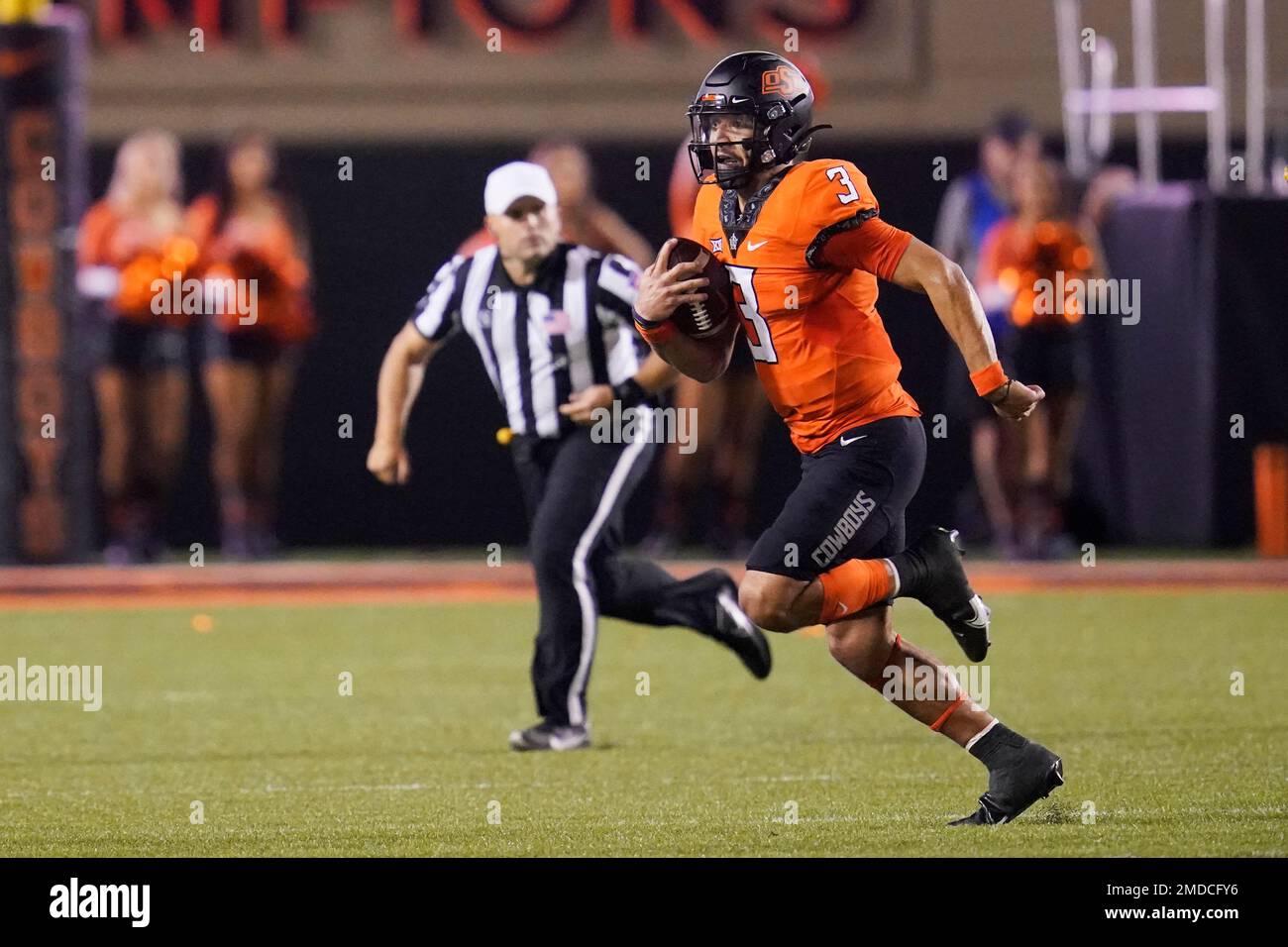 Oklahoma State quarterback Spencer Sanders (3) carries during NCAA