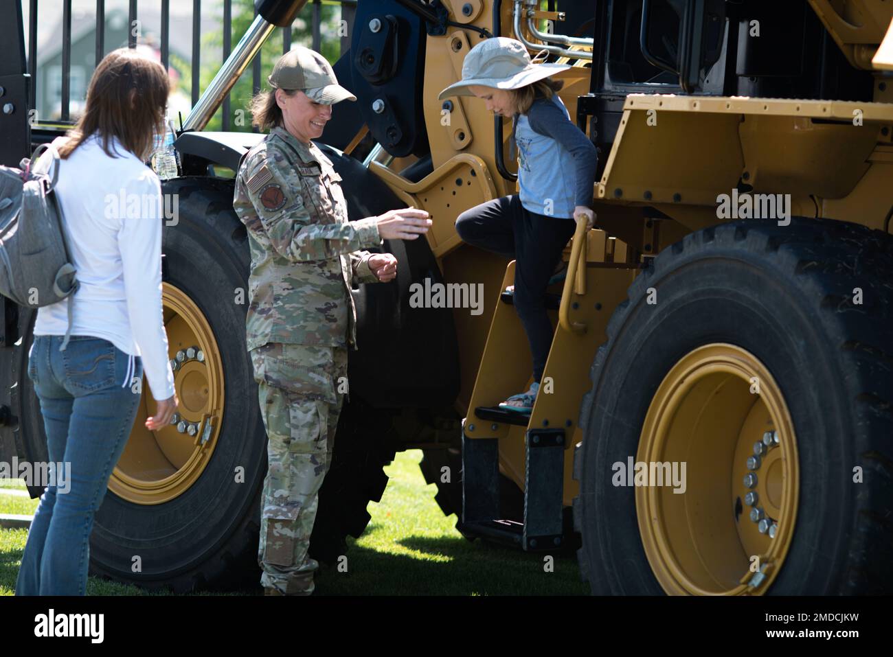 Tech. Sgt. Erin Harada 141 Civil Engineer Squadron helps a child down off a loader in Liberty Lake, Wash. July 15, 2022. The Airmen were out supporting the annual Touch-A-Truck event allowing both children and adults to check out heavy equipment from multiple agencies. Stock Photo