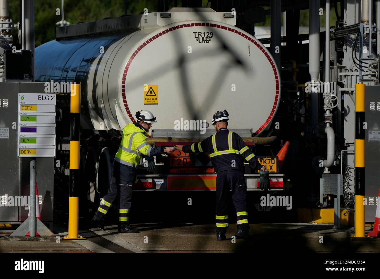 Workers prepare a fuel tanker at Buncefield Oil Depot near Hemel