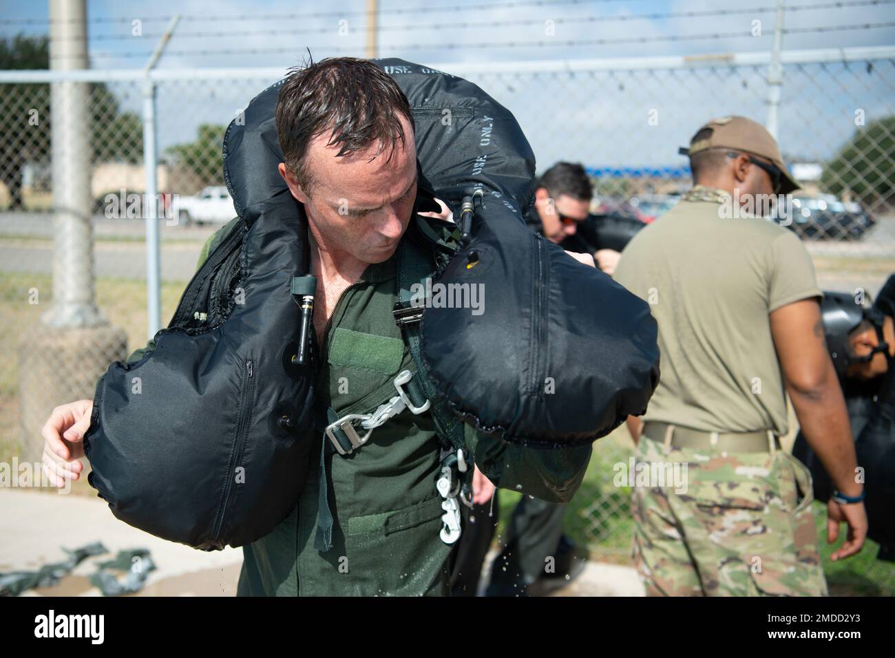 An F-16 instructor pilot from the 149th Fighter Wing, practices using survival equipment as part of water survival training at Joint Base San Antonio-Lackland, July 16, 2022. The pilots do this training every 36 months to remain confident in their abilities and their gear. Stock Photo