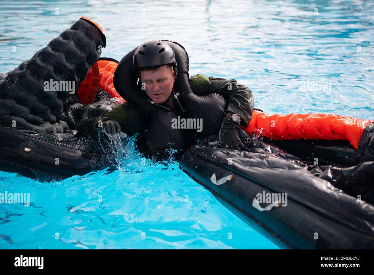 An F-16 instructor pilot from the 149th Fighter Wing, climbs onto a raft as part of water survival training at Joint Base San Antonio-Lackland, July 16, 2022. The pilots do this training every 36 months to remain confident in their abilities and their gear. Stock Photo