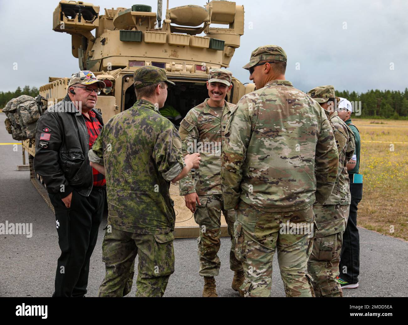U.S. Soldiers assigned to the 4th Squadron, 10th Cavalry Regiment, 3rd Armored Brigade Combat Team, 4th Infantry Division, speak with Finnish citizens at a static display during the Oripää Airshow at Säkylä, Finland, July 16, 2022. The 3rd Armored Brigade Combat Team, 4th Infantry Division, and the Pori Brigade of the Finnish army began summer training in Finland to strengthen relations and help build interoperability between the two nations. Stock Photo