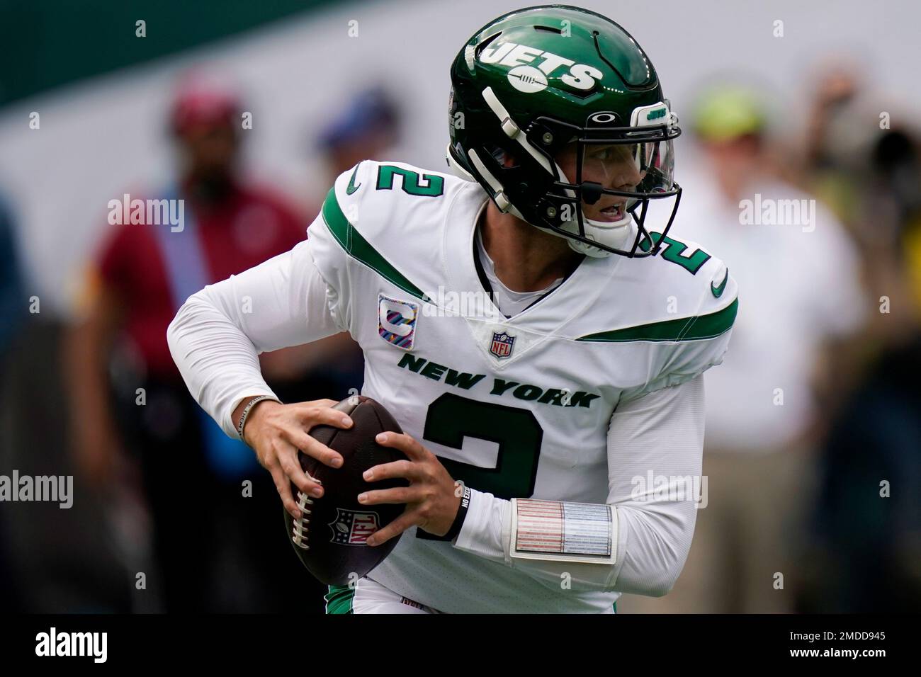 New York Jets quarterback Zach Wilson looks to pass on the run during the  first half of an NFL football game against the Tennessee Titans, Sunday, Oct.  3, 2021, in East Rutherford. (