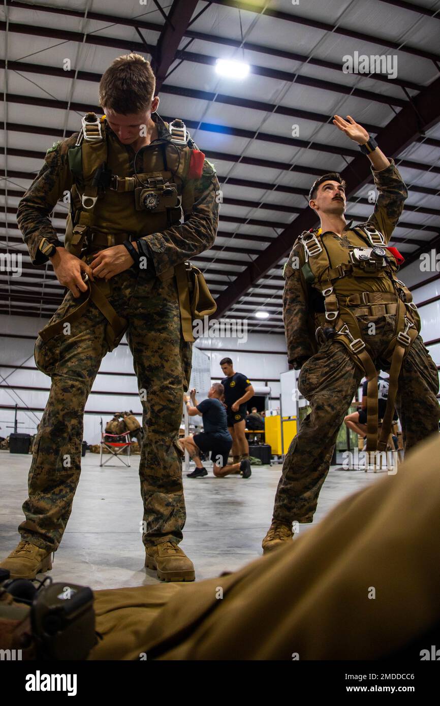 U.S. Marines with Force Reconnaissance Company, III Marine Expeditionary  Force, prepare and test their gear during high-altitude military parachute  training at Hearne Municipal Airport, Hearne, Texas, July 17, 2022. This  training was