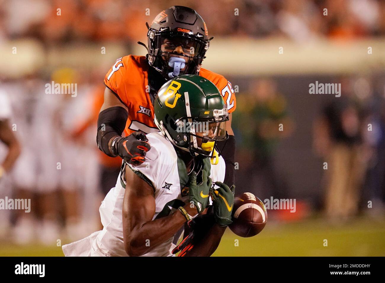 Oklahoma State cornerback Jarrick Bernard-Converse, rear, reaches in to  break up a pass intended for Baylor wide receiver Tyquan Thornton in the  second half of an NCAA college football game, Saturday, Oct.