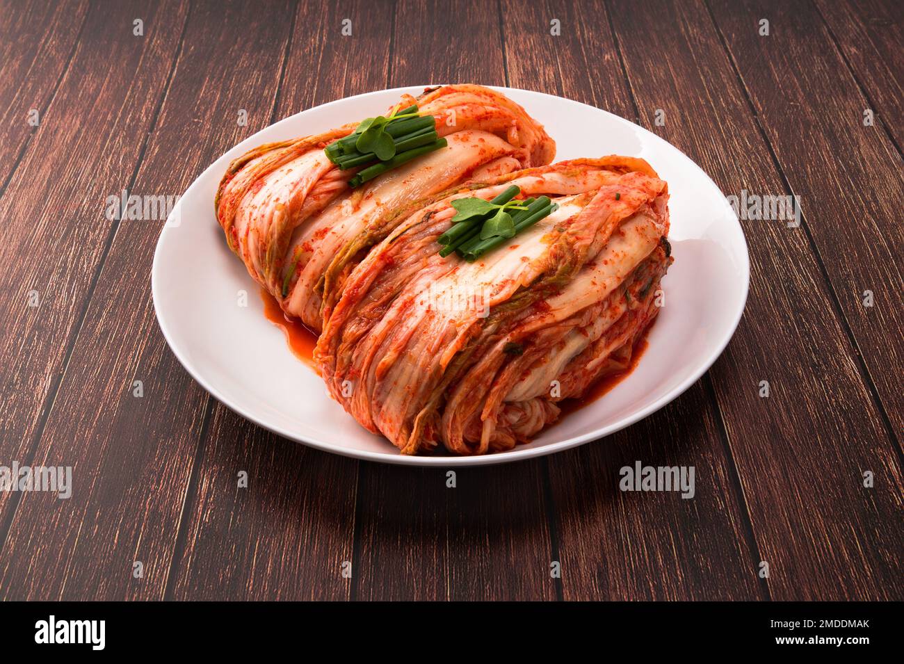 Korean kimchi. Korean traditional cabbage kimchi on white plate. Wood