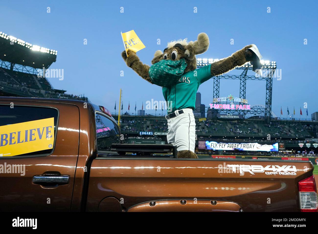 Moose, the Seattle Mariners mascot, wears a mask as he holds a sign that  reads Believe before a baseball game against the Los Angeles Angels,  Friday, Oct. 1, 2021, at T-Mobile Park