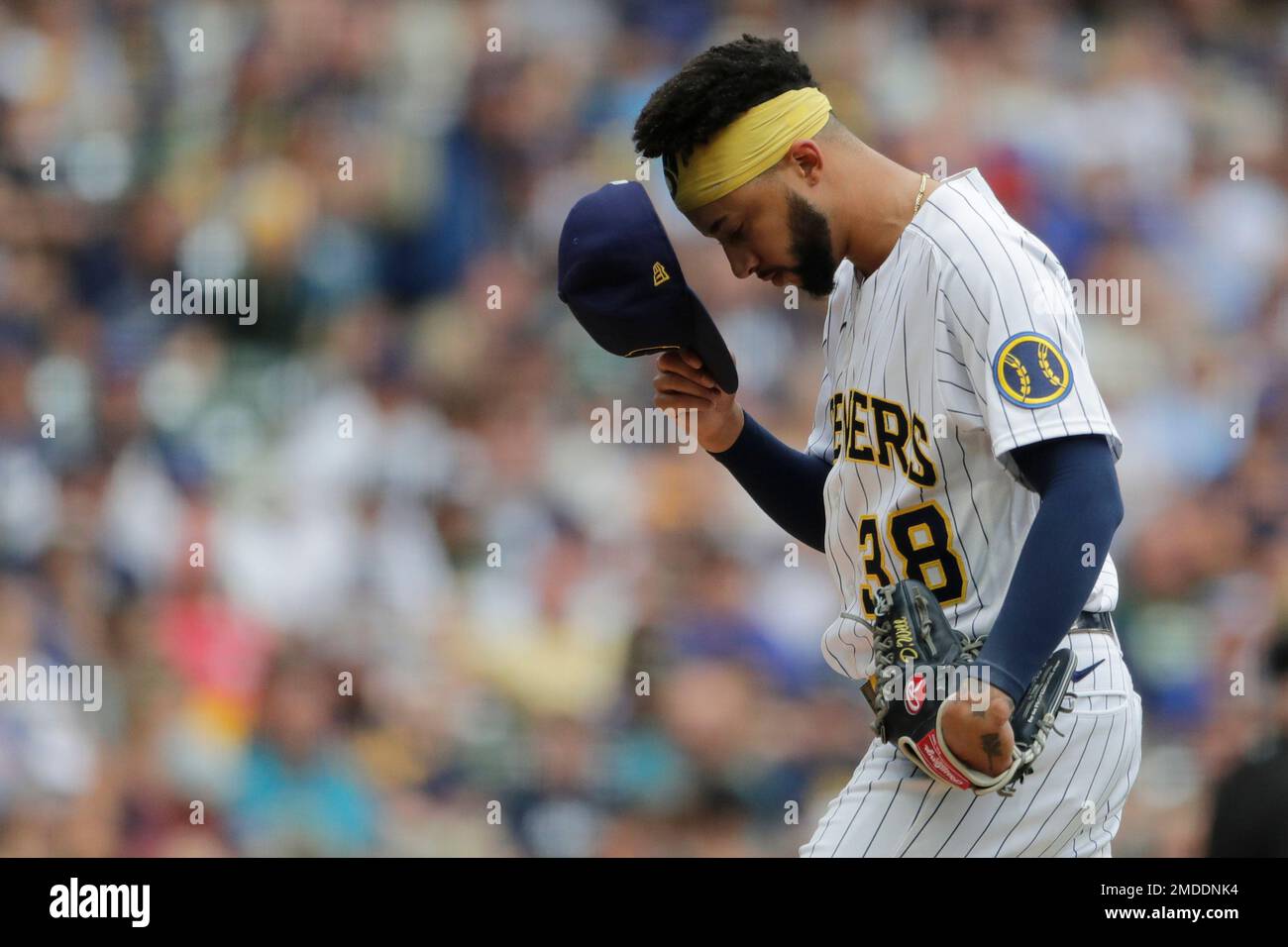 Milwaukee Brewers' Devin Williams pauses before pitching during