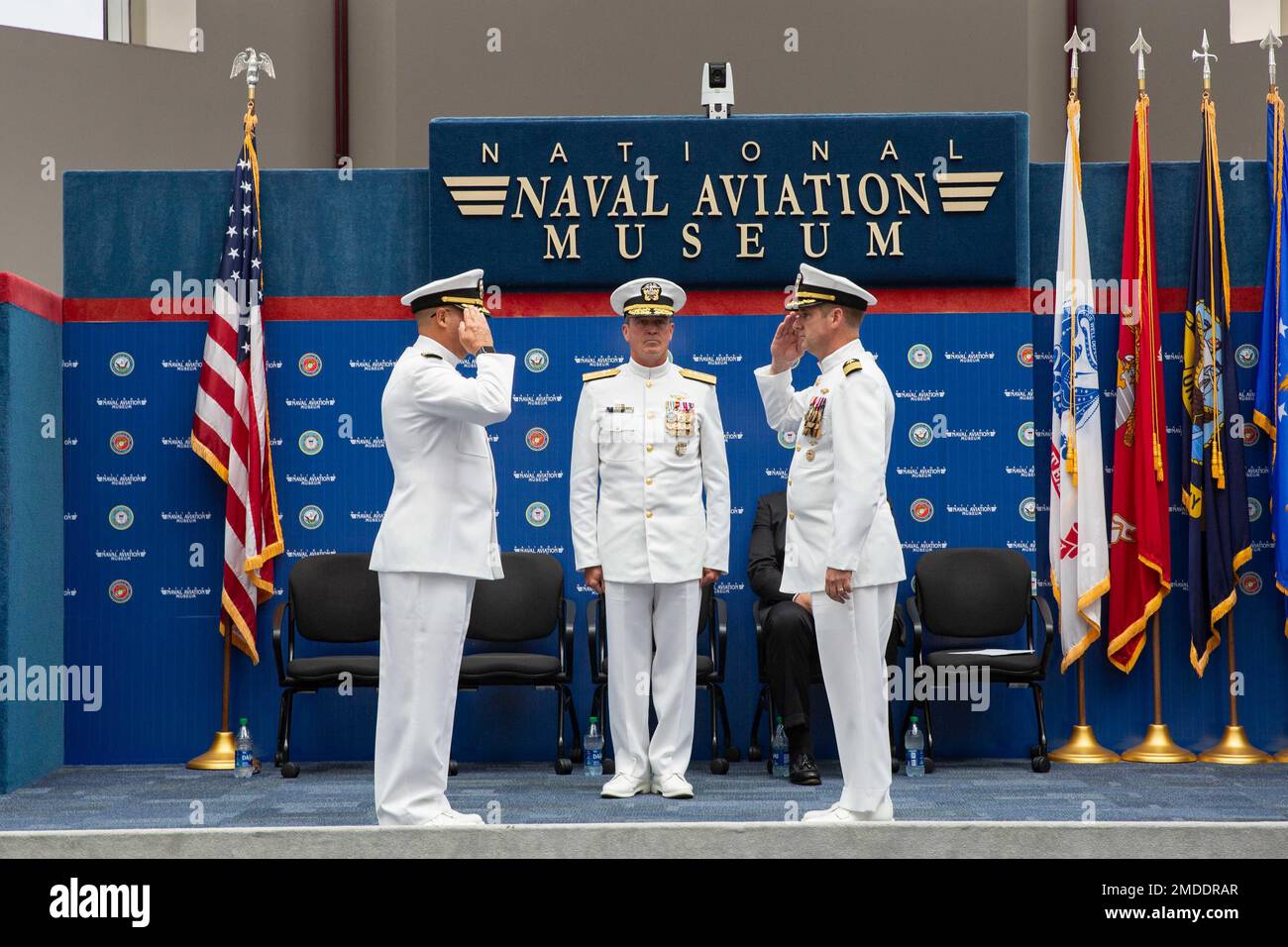 Capt. Christopher G. Bryant, right, relieves Capt. Marc W. Ratkus, left, as commanding officer, Center for Information Warfare Training (CIWT), with Rear Adm. Pete Garvin, commander, Naval Education and Training Command, center, presiding over the change of command ceremony, July 22, 2022.  The ceremony was held at the National Naval Aviation Museum and also included a retirement ceremony as Ratkus concluded his 39-year military career. CIWT is charged with developing the future technical cadre of the Navy’s information warfare community. Stock Photo