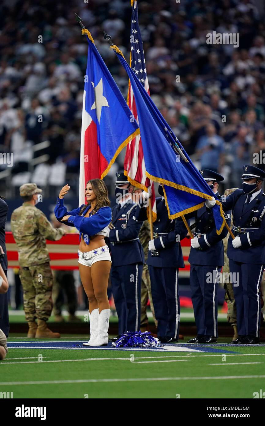 A Dallas Cowboys cheerleader performs sign language during the national anthem along with the ...