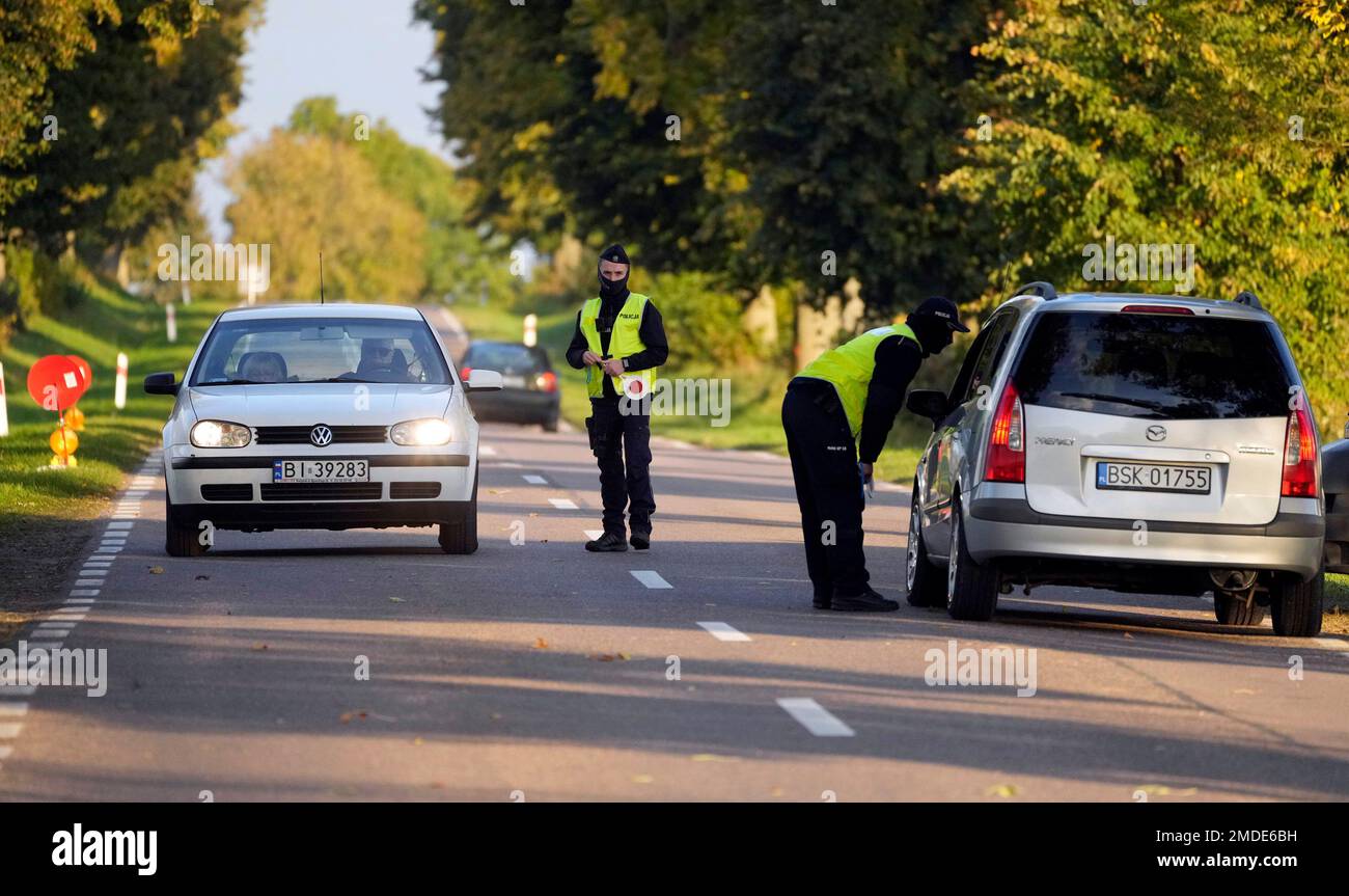 Polish police officers stop cars going in and out of an area along the  border with Belarus, where a state of emergency is in place, in Krynki,  Poland, Wednesday Sept. 29, 2021.
