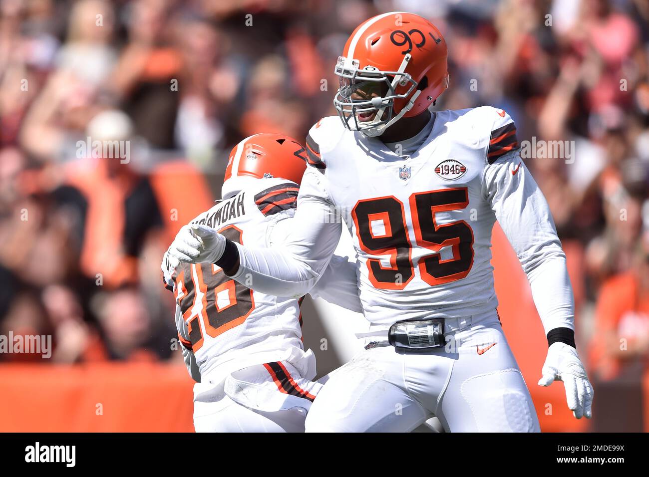 Cleveland Browns linebacker Jeremiah Owusu-Koramoah (28) and defensive end  Myles Garrett (95) celebrate during an NFL football game against the  Chicago Bears, Sunday, Sept. 26, 2021, in Cleveland. The Browns won 26-6. (