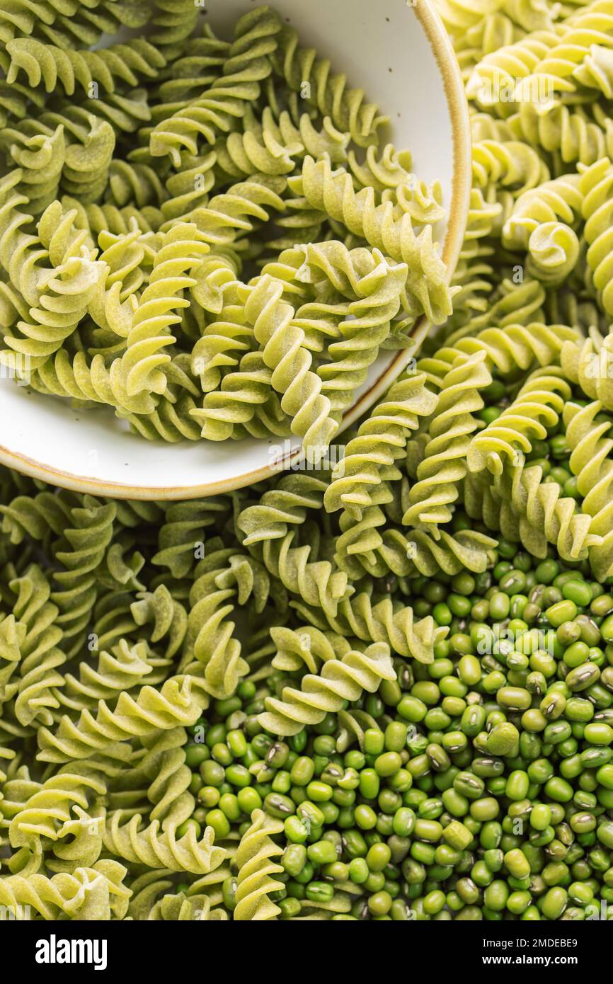 Mung bean fusilli pasta. Bowl with raw pasta and green mung bean