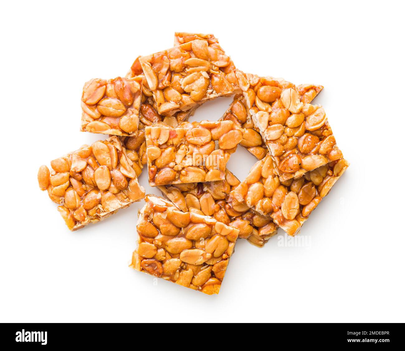 Sweet peanut brittle. Tasty peanuts in caramel isolated on the white background. Stock Photo