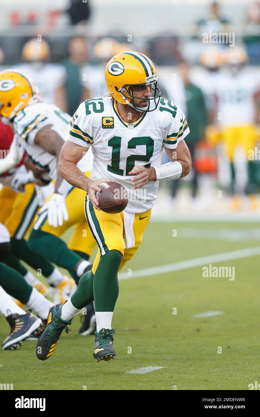 Green Bay Packers quarterback Aaron Rodgers (12) drops back with the