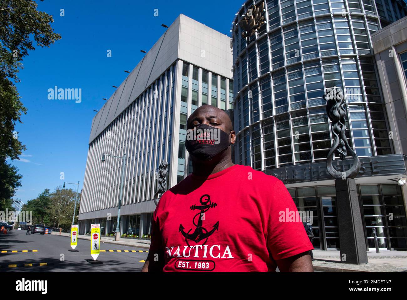 An unidentified supporter of R&B singer R. Kelly, wears a mask reading ...