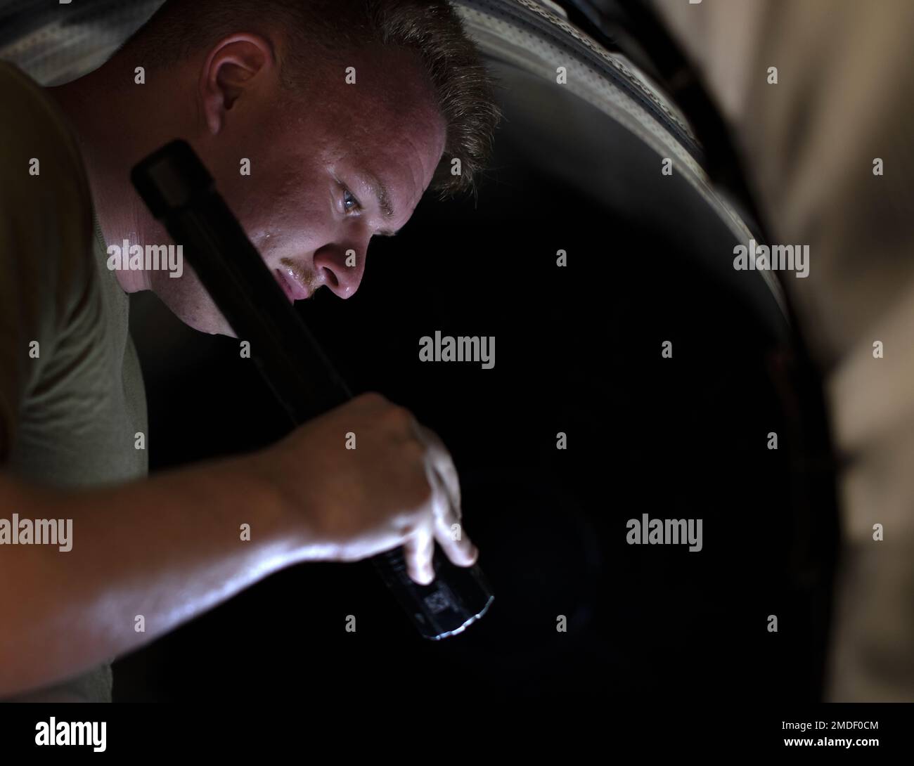 Airman 1st Class Dalton Crew, 18th Component Maintenance Squadron aerospace propulsion journeyman, conducts an exhaust inspection on an F-15C Eagle engine at Kadena Air Base, Japan, July 22, 2022. The exhaust inspection is done to ensure all engine parts are in place, damage free and ready to be reinstalled into the aircraft. Stock Photo