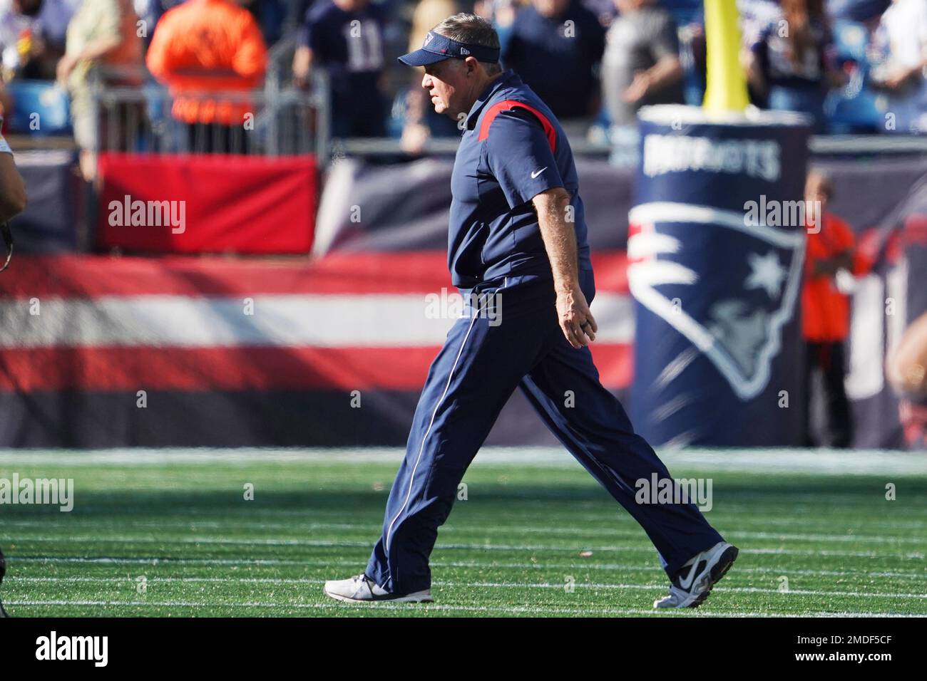 New England Patriots head coach Bill Belichick walks across the