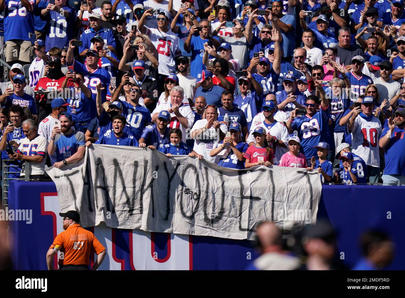 Fans honor former New York Giants quarterback Eli Manning as he addresses  the crowd during a ceremony to retire his jersey number 10 and celebrate  his tenure with the team during half-time