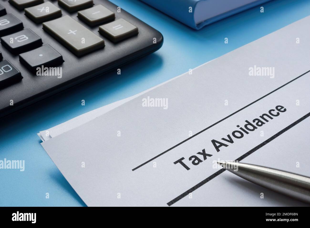 Papers about tax avoidance near the calculator. Stock Photo