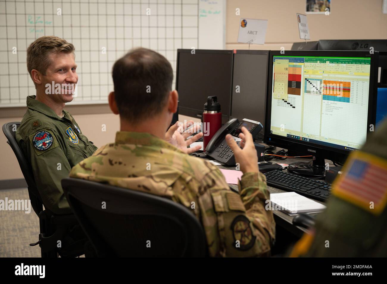 U.S. Air Force Maj. Russ Williams, left, 514th Air Mobility Operations Squadron tanker planner, and U.S. Air Force Lt. Col. Ryan Cengeri, right, 514th AMOS air refueling control team chief, participate in Internal Flex, their semi-annual Air Mobility Division exercise at the Weapon System Suite July 22, 2022, at Joint Base McGuire-Dix-Lakehurst, New Jersey. This exercise involved planning a priority mission for injured patients. Stock Photo