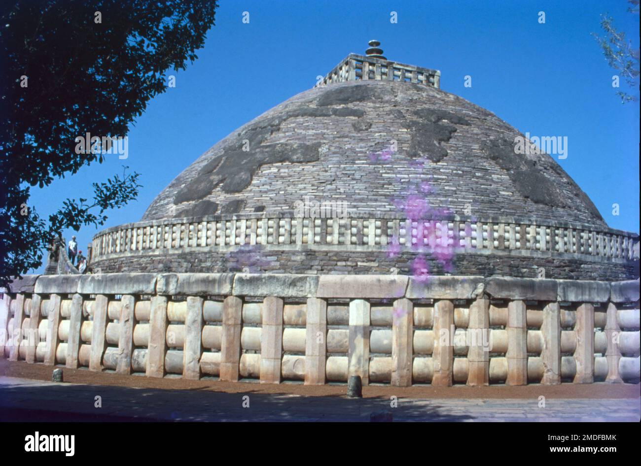 Sanchi is a Buddhist complex, famous for its Great Stupa, on a hilltop at Sanchi Town in Raisen District of the State of Madhya Pradesh, India. It is located, about 23 kilometres from Raisen town, district headquarter and 46 kilometres north-east of Bhopal, capital of Madhya Pradesh. The Great Stupa at Sanchi is one of the oldest stone structures in India, and an important monument of Indian Architecture. Torana, Indian gateway, usually of stone, marking the entrance to a Buddhist shrine or stupa or to a Hindu temple. Stock Photo