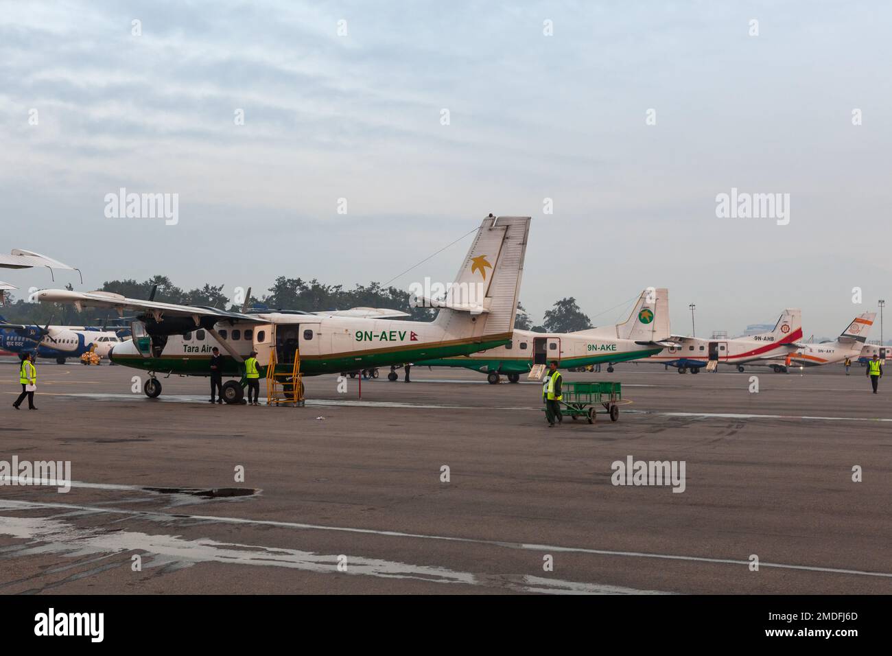 KATHMANDU/NEPAL - OCTOBER 18, 2015: Tara Air small airplane getting redy for take off to Lukla. Raw of small airplanes on airport grounds. Stock Photo