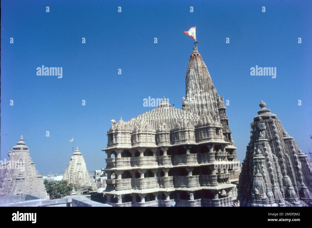 Dwarkadhish Temple, one of the Char Dham pilgrimages, is situated in the city of Dwarka in Gujarat. Dwarka lies on the banks of river Gomti. Dwarkadhish Temple also known as the Jagat Mandir, is a Chalukya styled architecture, dedicated to Lord Krishna. Stock Photo