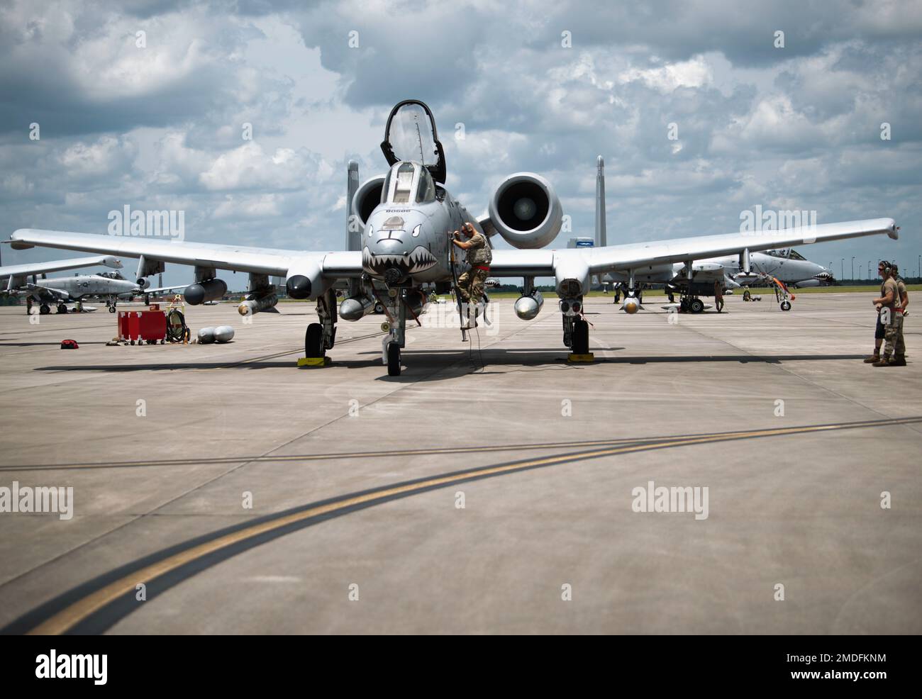 A U.S. Air Force Airman climbs up to the cockpit of an A-10C Thunderbolt II to communicate with the pilot before takeoff from Savannah Air National Guard Base, Georgia, July 22, 2022. Agile Flag 22-2 is Air Combat Command's first lead-wing certification event designed to demonstrate the 23rd Wing's capability to generate combat air power while continuing to move, maneuver, and sustain the Wing and subordinate force elements in a dynamic and contested environment. Stock Photo