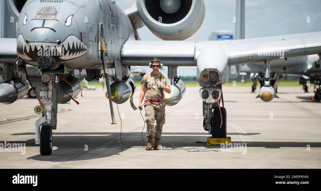A U.S. Air Force Airman assigned to the 23rd Wing makes his way around an A-10C Thunderbolt II for a pre-flight check during exercise Agile Flag 22-2 at Savannah Air National Guard Base, Georgia, July 22, 2022.   Agile Flag 22-2 is Air Combat Command's first lead-wing certification event designed to demonstrate the 23rd Wing's capability to generate combat air power while continuing to move, maneuver, and sustain the Wing and subordinate force elements in a dynamic and contested environment. Stock Photo