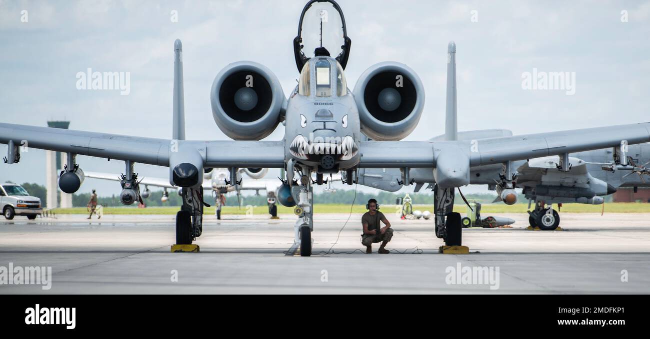 A U.S. Air Force Airman assigned to the 23rd Wing inspects an A-10C Thunderbolt II during a pre-flight check at Savannah Air National Guard Base, Georgia, July 22, 2022. Agile Flag 22-2 is Air Combat Command's first lead-wing certification event designed to demonstrate the 23rd Wing's capability to generate combat air power while continuing to move, maneuver, and sustain the Wing and subordinate force elements in a dynamic and contested environment. Stock Photo