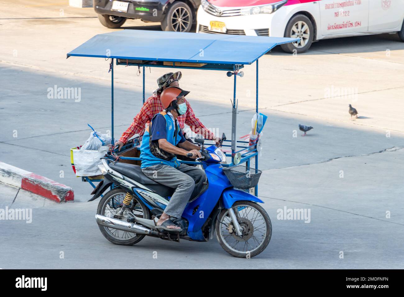 SAMUT PRAKAN, THAILAND, FEB 25 2022, Mototaxi driver with a sidecar ride on the street Stock Photo