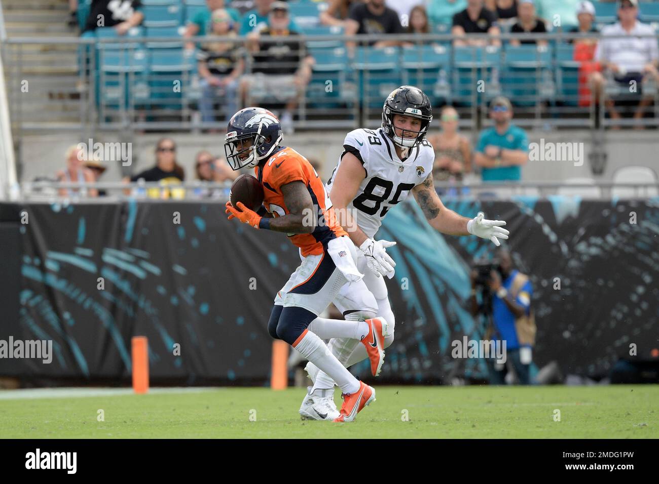 Denver Broncos safety Kareem Jackson (22) intercepts a pass intended for  Jacksonville Jaguars tight end Luke Farrell (89) during the second half of  an NFL football game, Sunday, Sept. 19, 2021, in