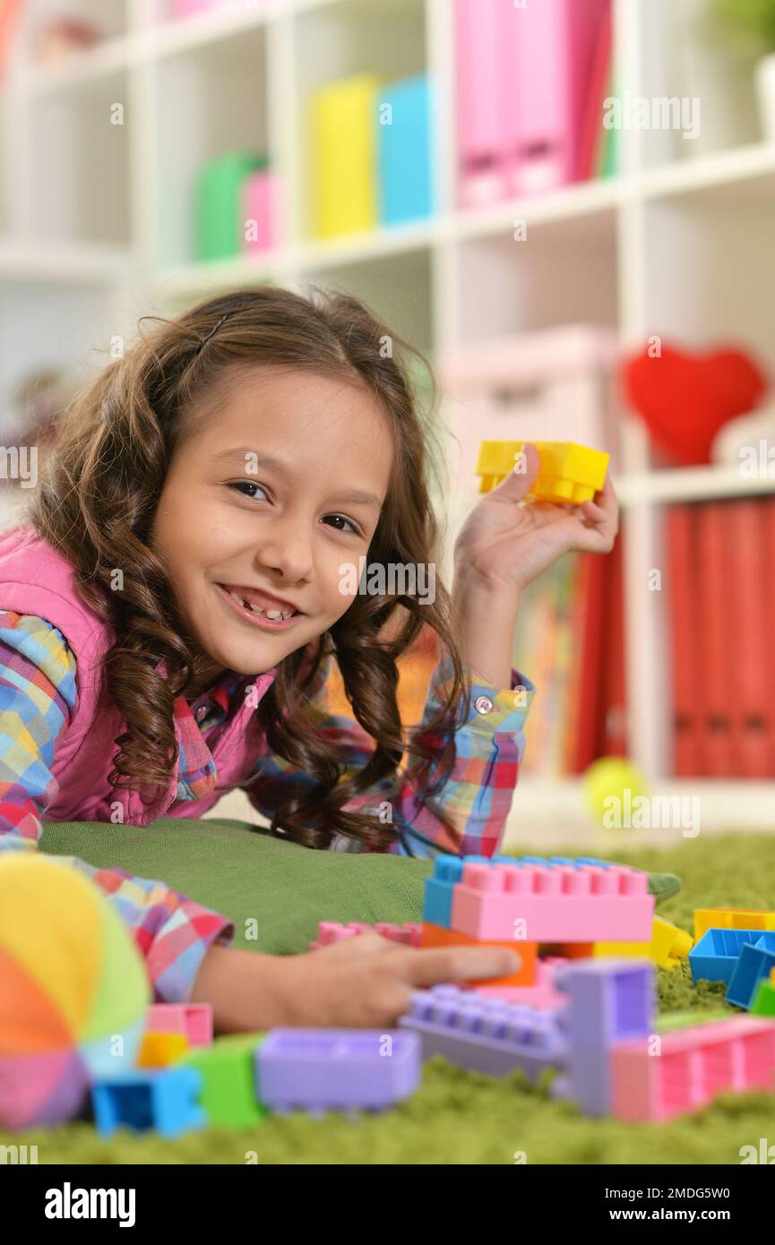 little girl playing with colorful plastic block Stock Photo - Alamy