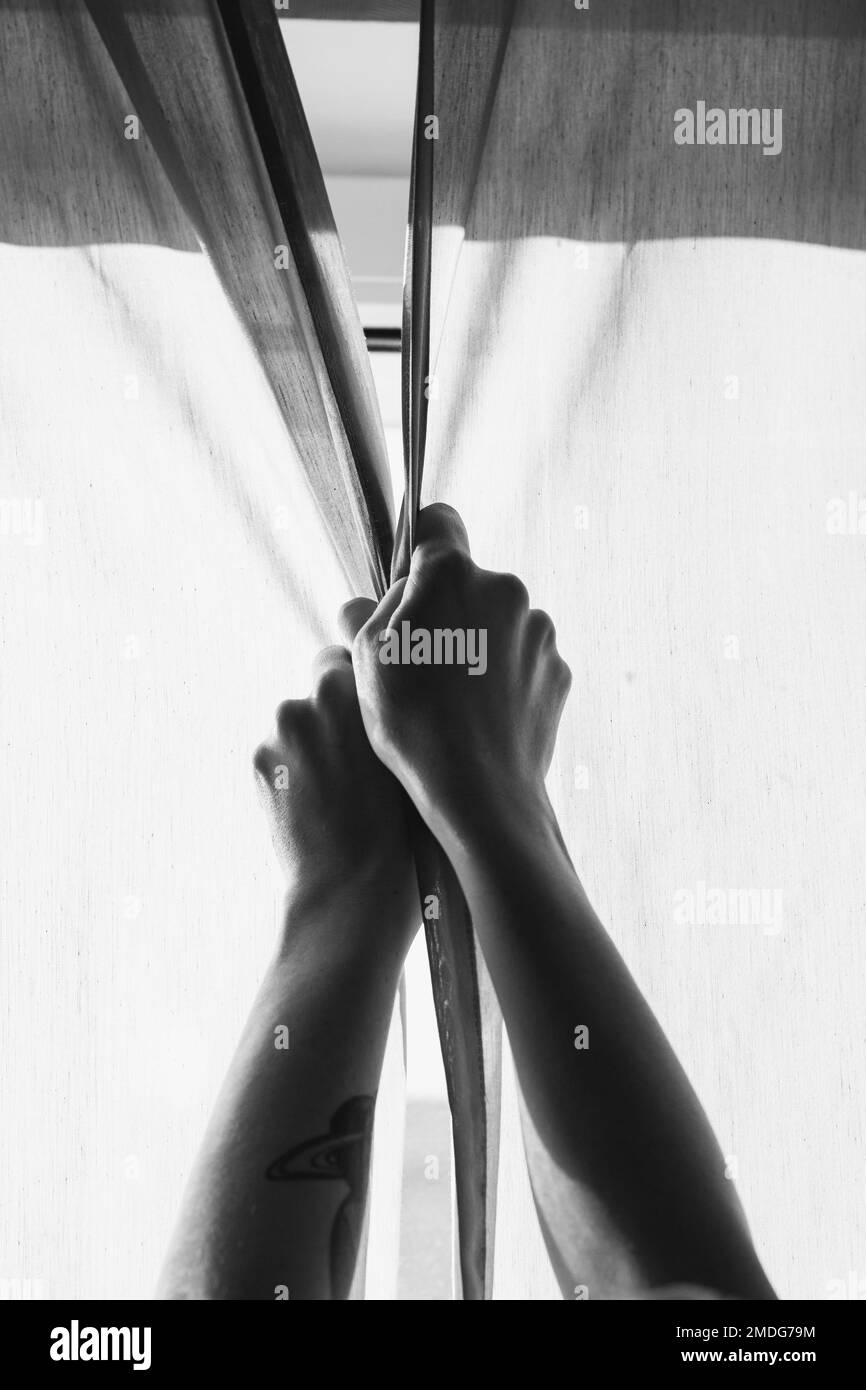 Close up hands closing curtains monochrome concept photo Stock Photo