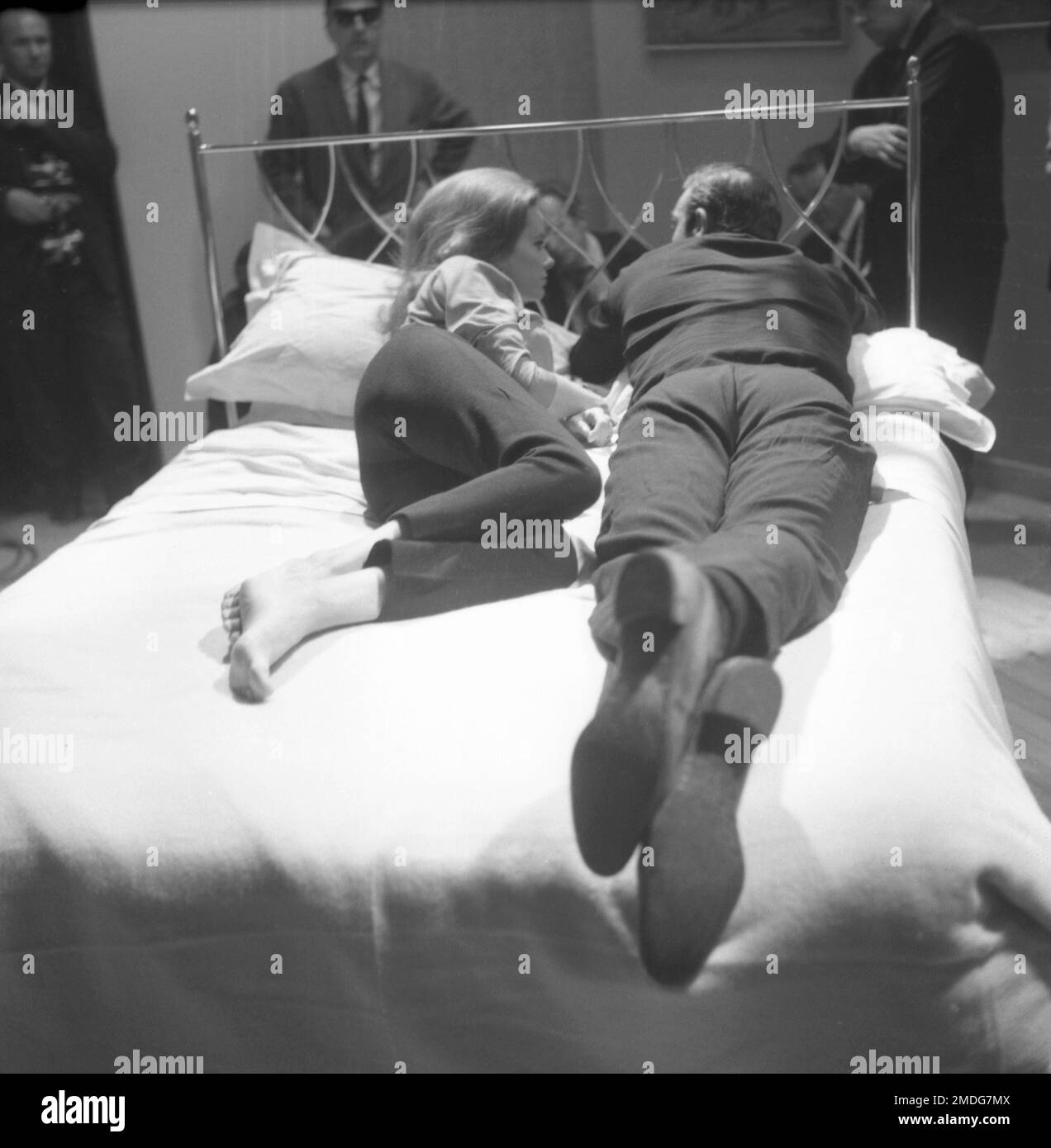 Italian actress Luciana Paluzzi, lies on a bed with secret agent 