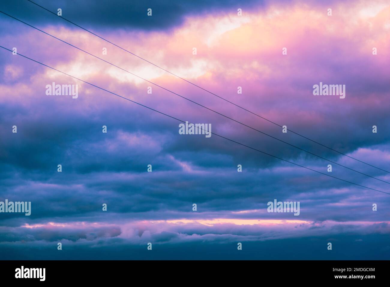 A beautiful pink and blue cloudy sky over the power lines Stock Photo ...